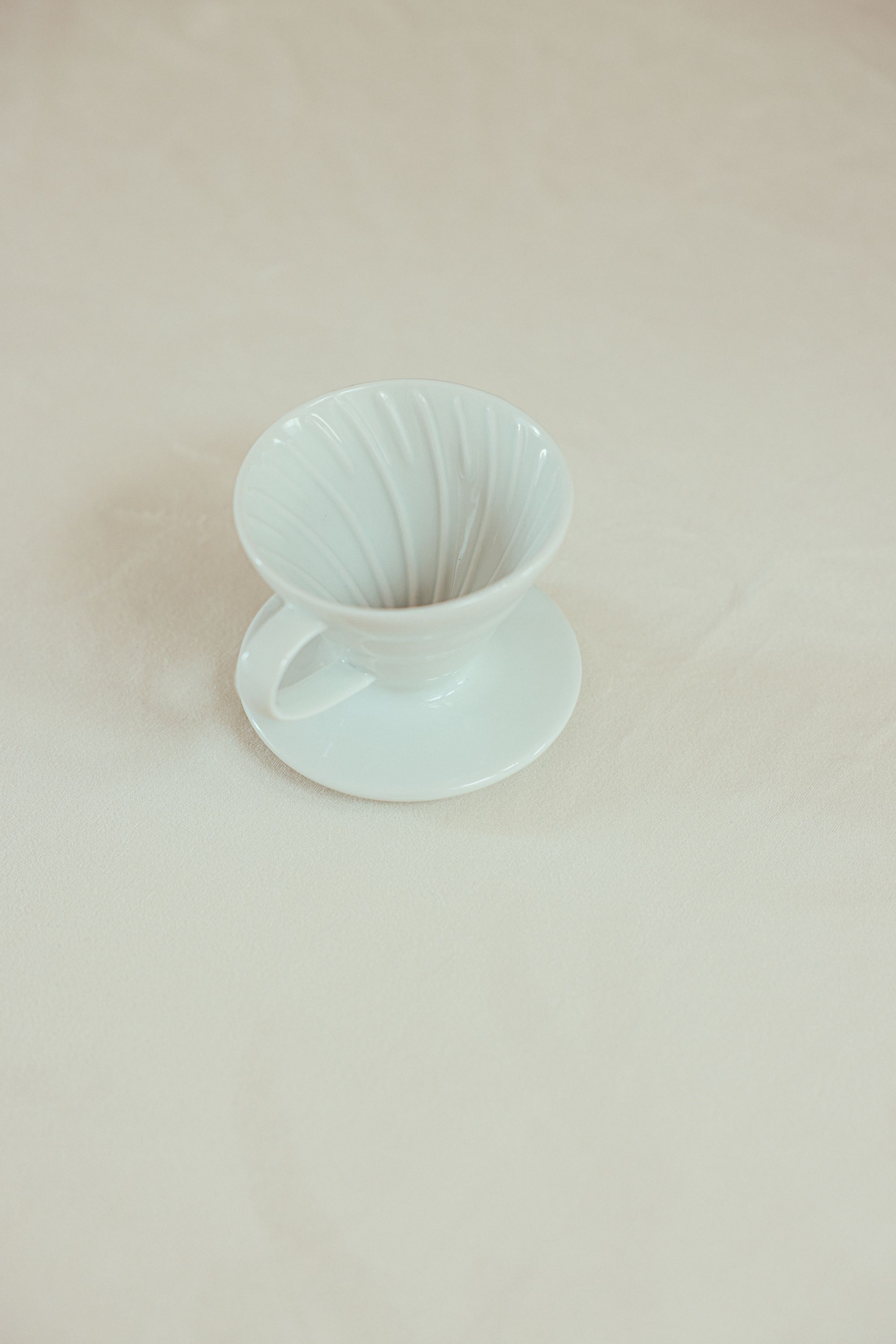 Original photograph of a white ceramic coffee dripper
